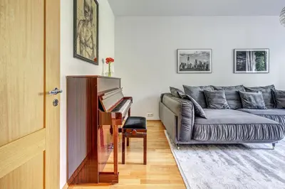 a living room with a couch and a piano at Elegant 2-Bedroom in city center in Vilnius