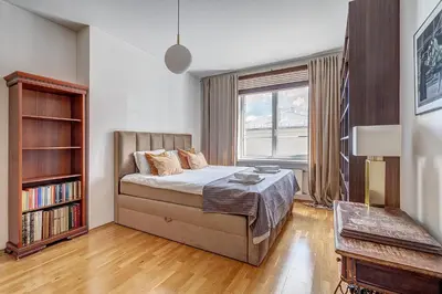 a bedroom with a bed and a book shelf at Elegant 2-Bedroom in city center in Vilnius