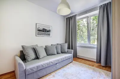 a living room with a couch and a window at Elegant 2-Bedroom in city center in Vilnius