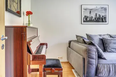 a living room with a couch and a piano at Elegant 2-Bedroom in city center in Vilnius
