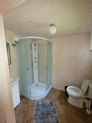 a bathroom with a shower and a toilet at Šeimos namelis nr2-Mindūnų sodyba in Pakopi