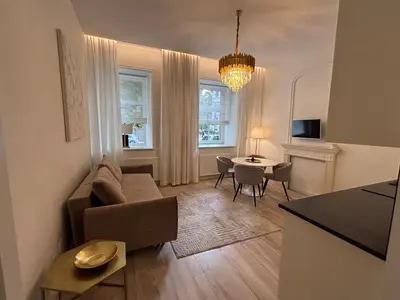 a living room with a couch and a table at Luxury Apartment Self Check-In in Vilnius
