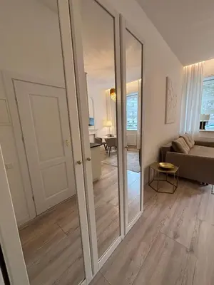 a living room with a sliding glass door at Luxury Apartment Self Check-In in Vilnius