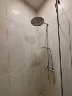 a shower with a glass door in a bathroom at Luxury Apartment Self Check-In in Vilnius