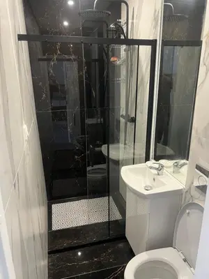 a bathroom with a shower and a toilet and a sink at Next door airport apartmens in Karmėlava