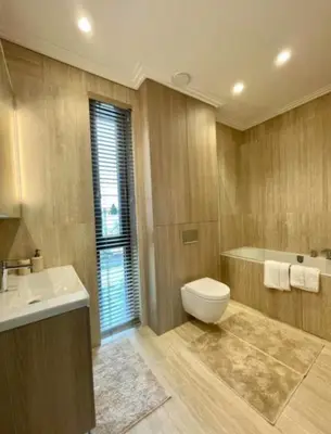 a bathroom with a toilet and a sink at sf ghjk in Užliedžiai