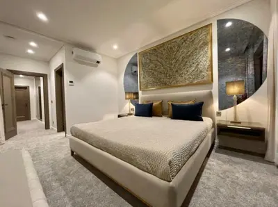 a bedroom with a bed and a painting on the wall at sf ghjk in Užliedžiai