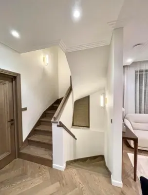 a staircase in a house with a couch and a chair at sf ghjk in Užliedžiai