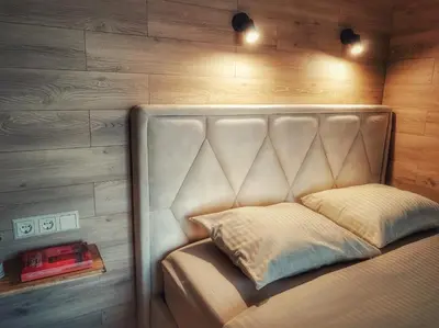 a bed with a padded headboard in a bedroom at Tytų Vila in Tytuvėnai
