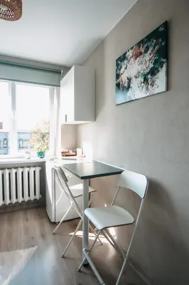 a dining room with a table and two chairs at Central Park Apartment in Šiauliai