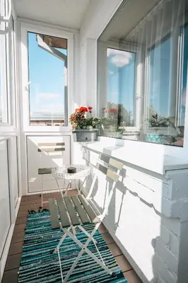 a balcony with a table and a window at Central Park Apartment in Šiauliai