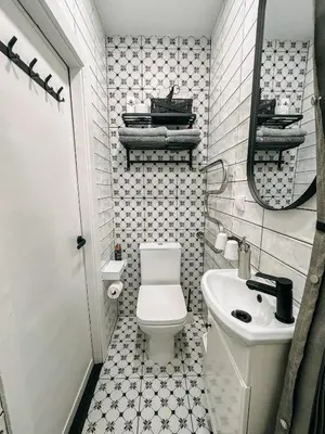 a small bathroom with a toilet and a sink at Central Park Apartment in Šiauliai