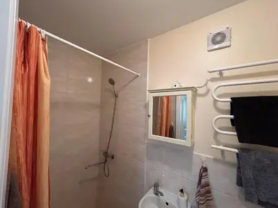 a bathroom with a shower and a toilet and a sink at Bocmano vila in Meteliai