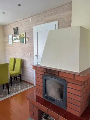 a brick fireplace in a living room with at Bocmano vila in Meteliai