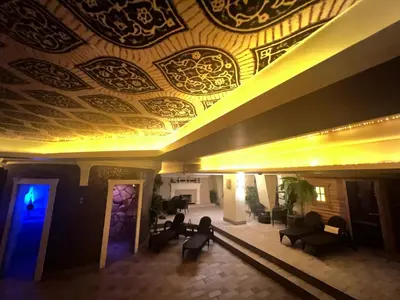 a living room with a ceiling with a painting on it at Jovarelis in Vilnius