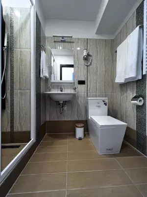 a bathroom with a sink and a toilet and a mirror at Jovarelis in Vilnius