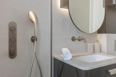 a bathroom with a sink and a mirror at SongInn Deco Apartment in Kaunas