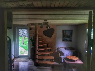 a room with a spiral staircase in a house at Cozy stay in village