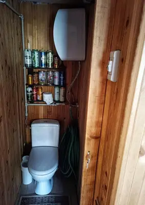 a small bathroom with a toilet in a room at Cozy stay in village