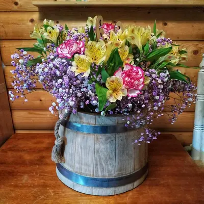 a bouquet of flowers in a wooden barrel at Cozy stay in village