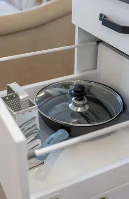 a frying pan in a drawer of an appliance at Vincent Sunlight Stay - Near Clinic, Arena and Stadium in Kaunas