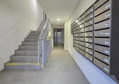 a hallway with a staircase and a bunch of mail boxes at Vincent Sunlight Stay - Near Clinic, Arena and Stadium in Kaunas