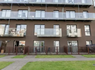 an apartment building with windows and a balcony at Vincent Sunlight Stay - Near Clinic, Arena and Stadium in Kaunas