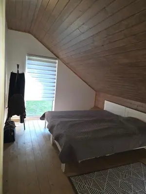 a bedroom with a bed and a wooden ceiling at Friend's homestead