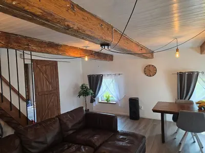 a living room with a couch and a table at Friend's homestead