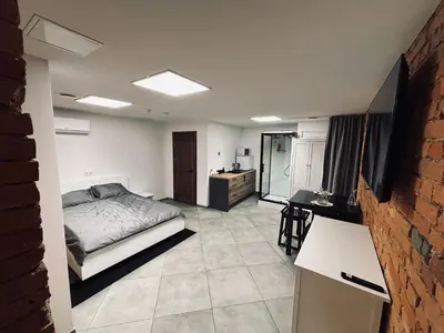 a bedroom with a bed and a desk in it at 69 apartaments II in Panevėžys