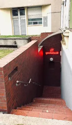 a brick wall with a red sign on it at 69 apartaments II in Panevėžys