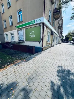 a sign on the side of a building on a street at 69 apartaments II in Panevėžys