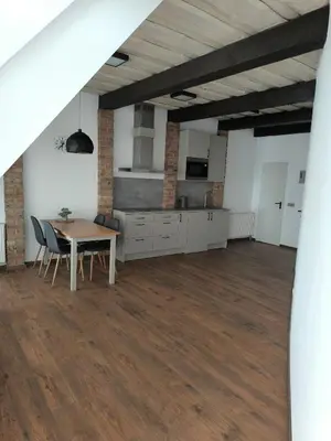 a kitchen and dining room with a table and chairs at Apartamentai1 in Utena