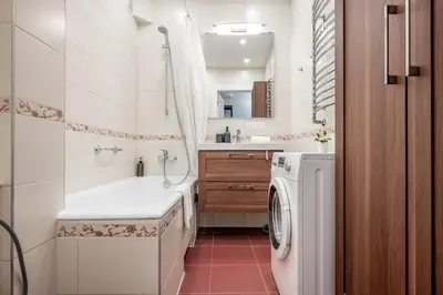 a bathroom with a washing machine and a washer at Vokieciu st Apt with Balcony I In the Center of it All I cohost in Vilnius