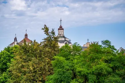 a building with two domes on top of trees at Vokieciu st Apt with Balcony I In the Center of it All I cohost in Vilnius