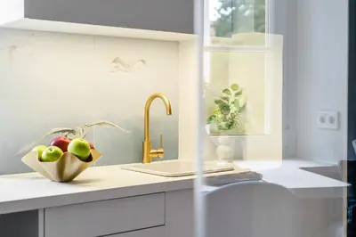 a kitchen with a sink and a bowl of apples at Blue Old Town apartment in Vilnius