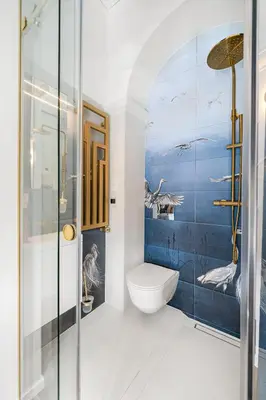 a bathroom with a toilet and a blue wall at Blue Old Town apartment in Vilnius