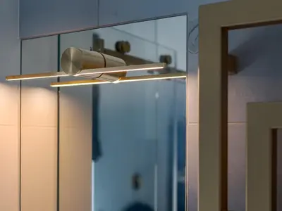 a bathroom with a light hanging from a mirror at Blue Old Town apartment in Vilnius