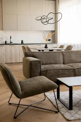a living room with a couch and a table at Alėjos apartamentai in Šiauliai