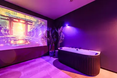 a purple bathroom with a tub and a large aquarium at Jacuzzi Cinema Japandi 2 in Kaunas