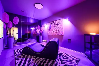 a living room with purple lighting and a couch at Jacuzzi Cinema Japandi 2 in Kaunas