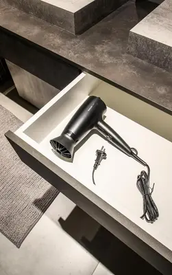 a black hairdryer on a shelf in a drawer at Jacuzzi Cinema Wabi Sabi 3 in Kaunas