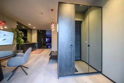 an office with glass walls and a desk and a chair at Jacuzzi Cinema Wabi Sabi 3 in Kaunas