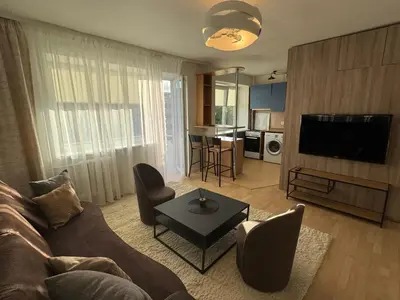 a living room with a couch and a tv at Central apartament II in Šiauliai