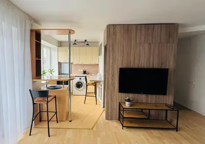 a living room with a flat screen tv on a wall at Central apartament II in Šiauliai