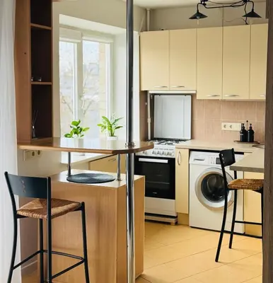 a kitchen with a table and a dishwasher at Central apartament II in Šiauliai