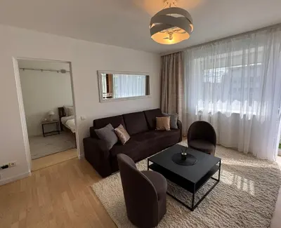 a living room with a couch and a table at Central apartament II in Šiauliai
