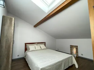 a bedroom with a white bed and a skylight at newTown 1 in Kaunas