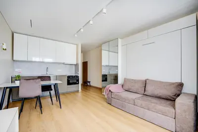 a living room with a couch and a table at Pradoli apartament in Vilnius