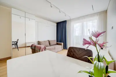 a living room with a table and a couch at Pradoli apartament in Vilnius